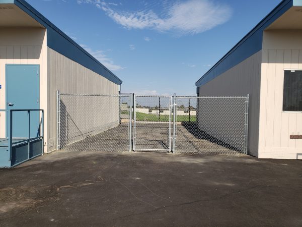 Chain-link security gate at a school compound by Inland Empire Fencing, ensuring a safe and secure educational environment.