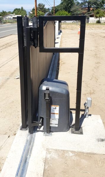 Commercial slide gate operator mounted beside a gate, providing a seamless and secure entry system, expertly installed by Inland Empire Fencing specialists.