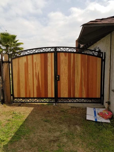Metal-framed wooden fence segments, integrating strength and style for a residential perimeter solution.