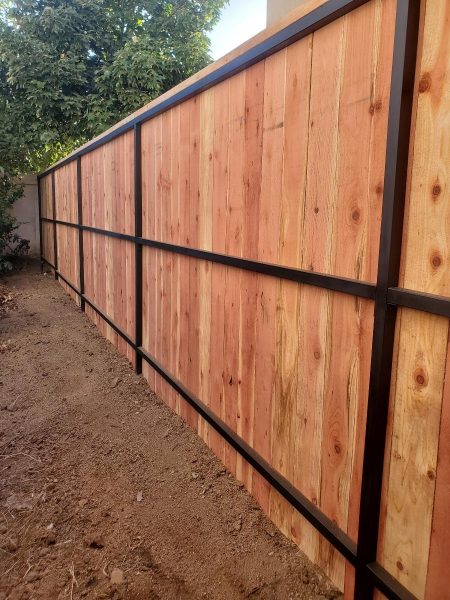 A two-panel wood driveway gate providing a combination of privacy and access control, illustrating Inland Empire Fencing's commitment to quality and design.