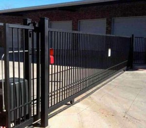 Impressive industrial sliding gate with automated controls, offering a seamless blend of functionality and a polished aesthetic for top-tier security.